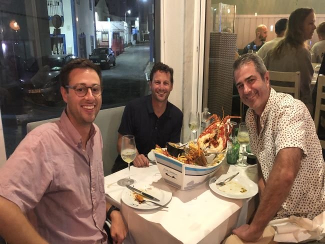 Sean, his buddy, and our own Miles Bent (left) enjoying dinner on the “trail.” Look at the size of that seafood platter!